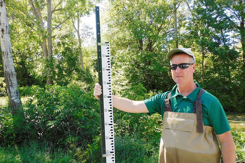 Ross Wilson, Water and Soils Resource Coordinator, with water level gauge.